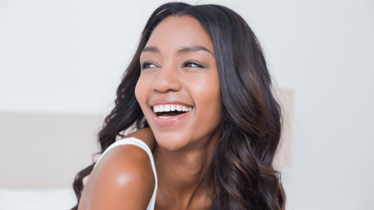 Beautiful black African American woman looking over her shoulder and smiling
